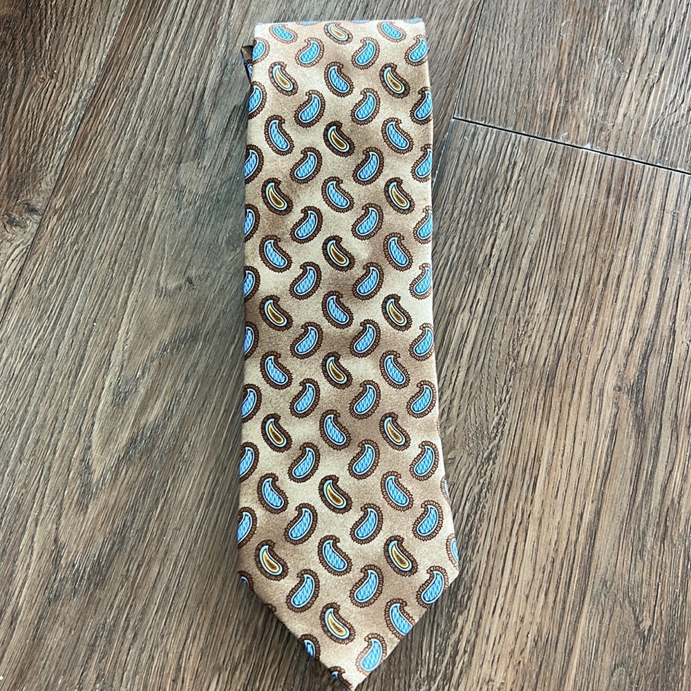 Ermenegildo Zegna paisley tie in gold/bronze with blue accents.